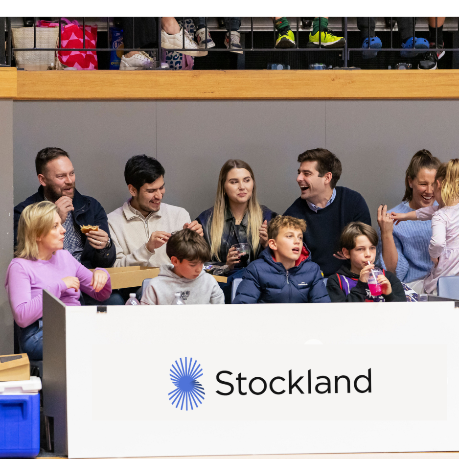 Guests seated in a branded courtside hospitality box at a Geelong home game