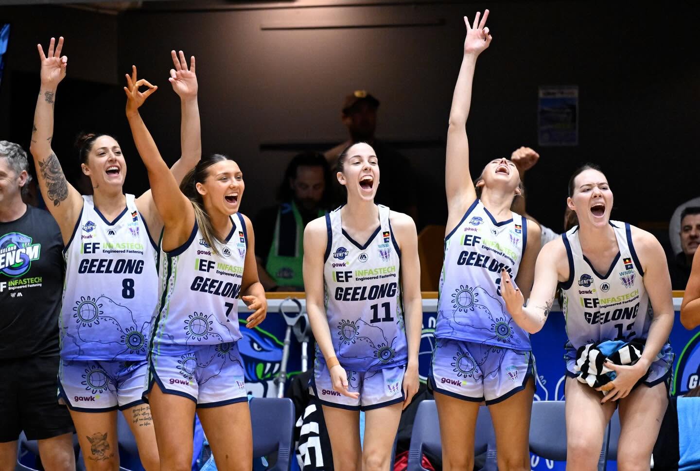 Geelong Venom players celebrating on court in front of home supporters