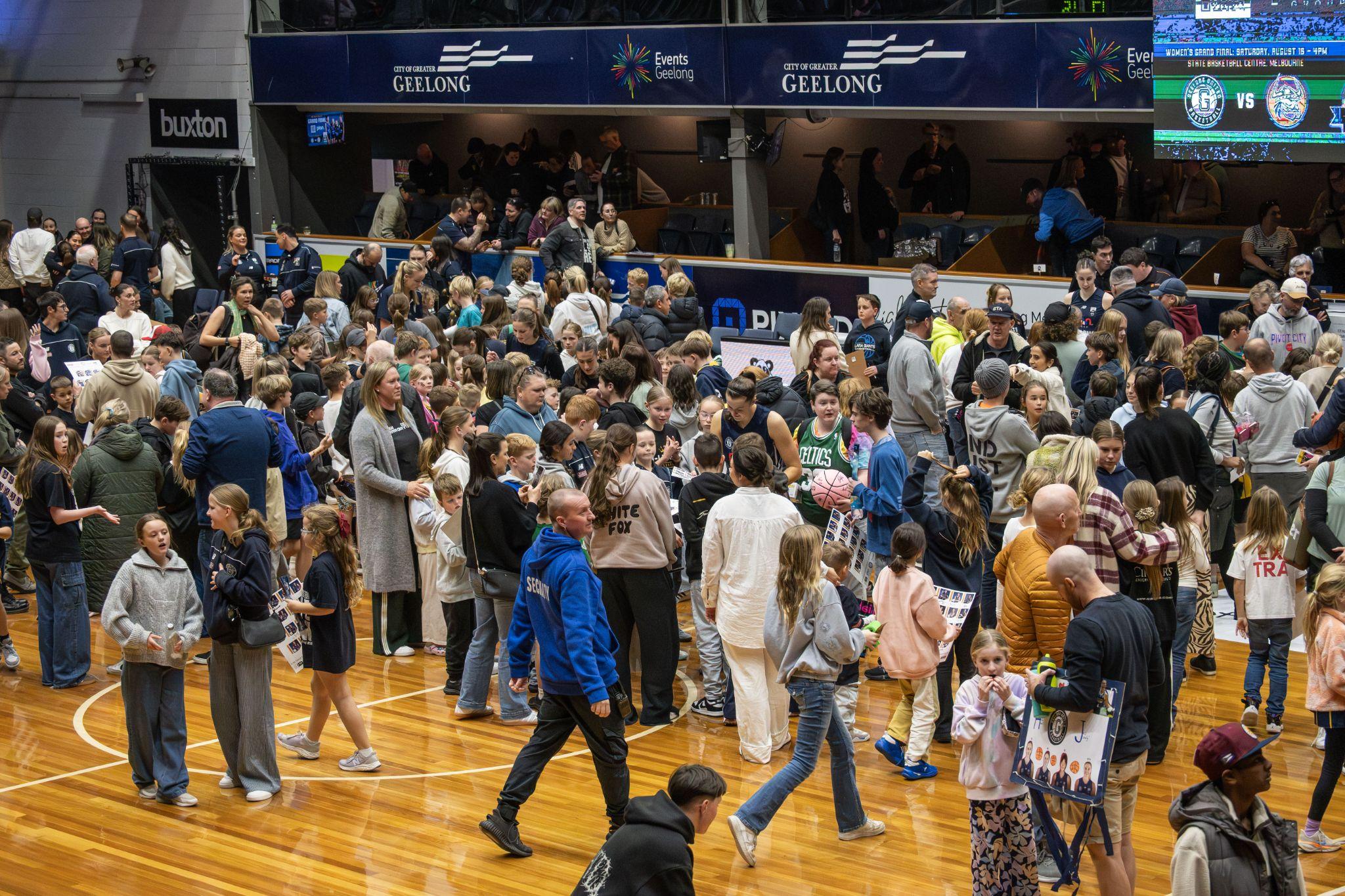 Supporters filling the court after a Geelong basketball home game
